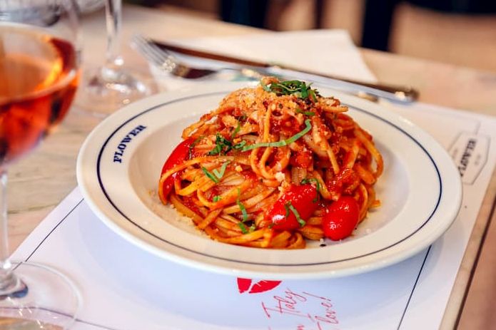 Pasta with cherry tomatoes on a white plate