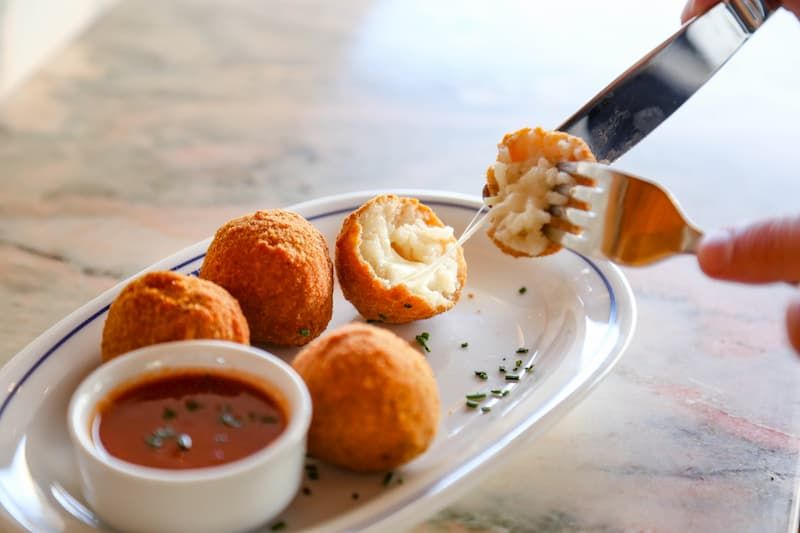 Croquettes with a tomato dip on a plate
